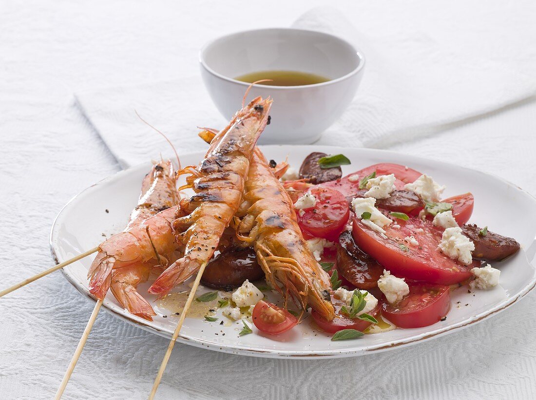 Tomato salad with skewered prawns, chorizo and feta cheese