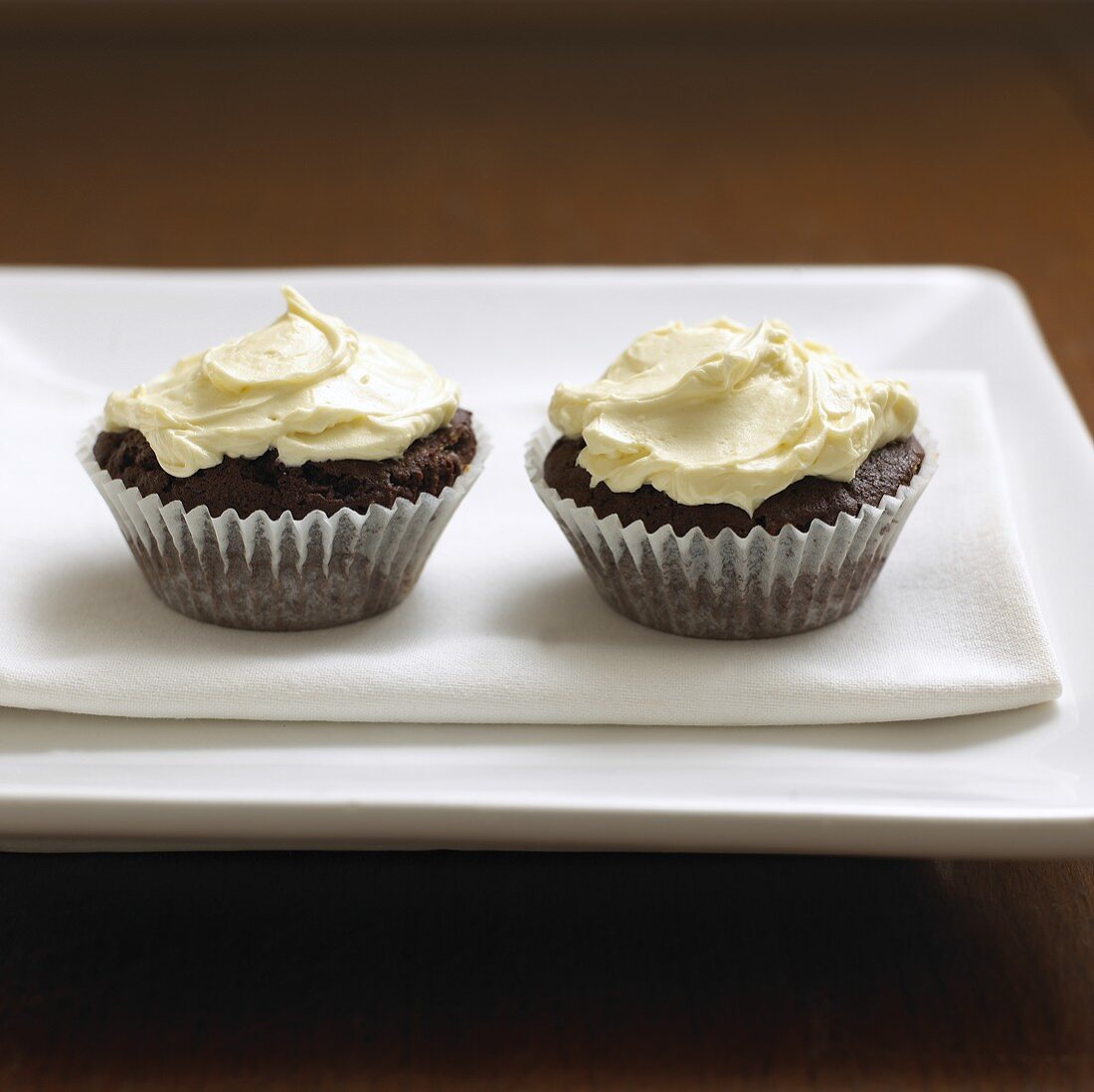 Two cupcakes on fabric napkin