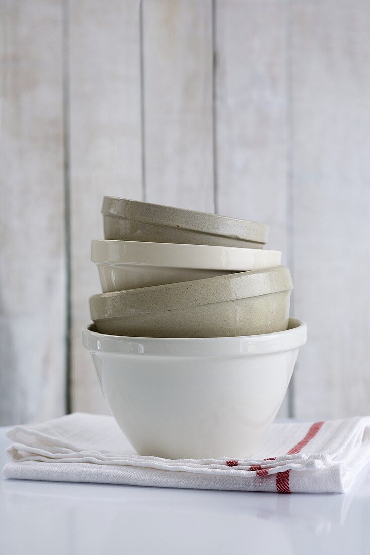 Stacked ceramic basins on tea towel