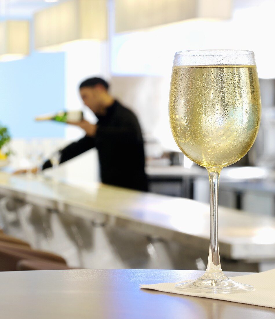 A glass of white wine in a restaurant