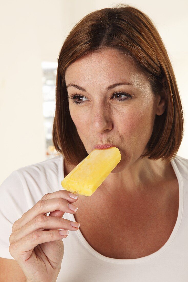 A woman eating an ice lolly