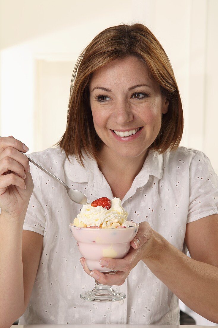 A woman eating a sundae