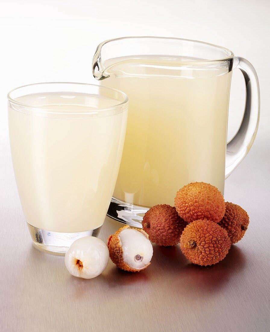 Lychee juice in a glass and a glass jug