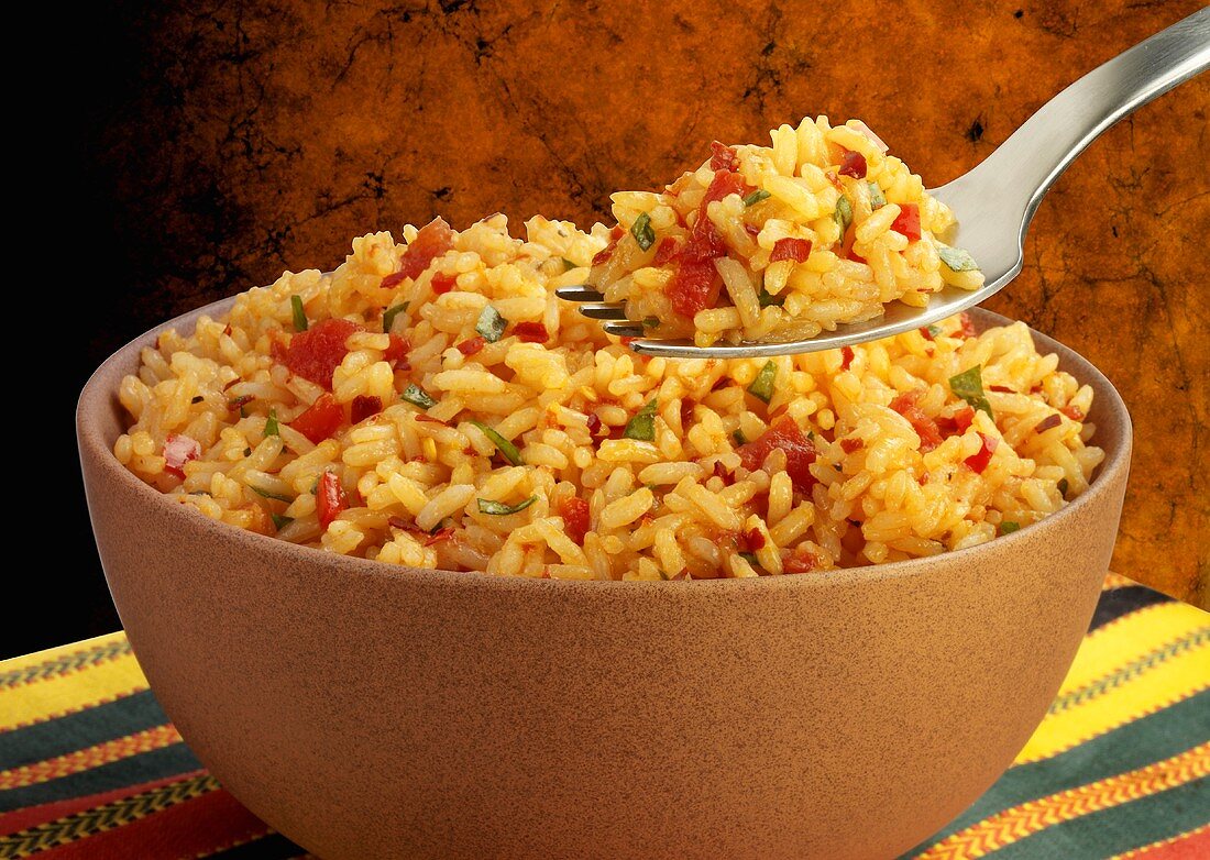 Tomato rice in a bowl and on a fork