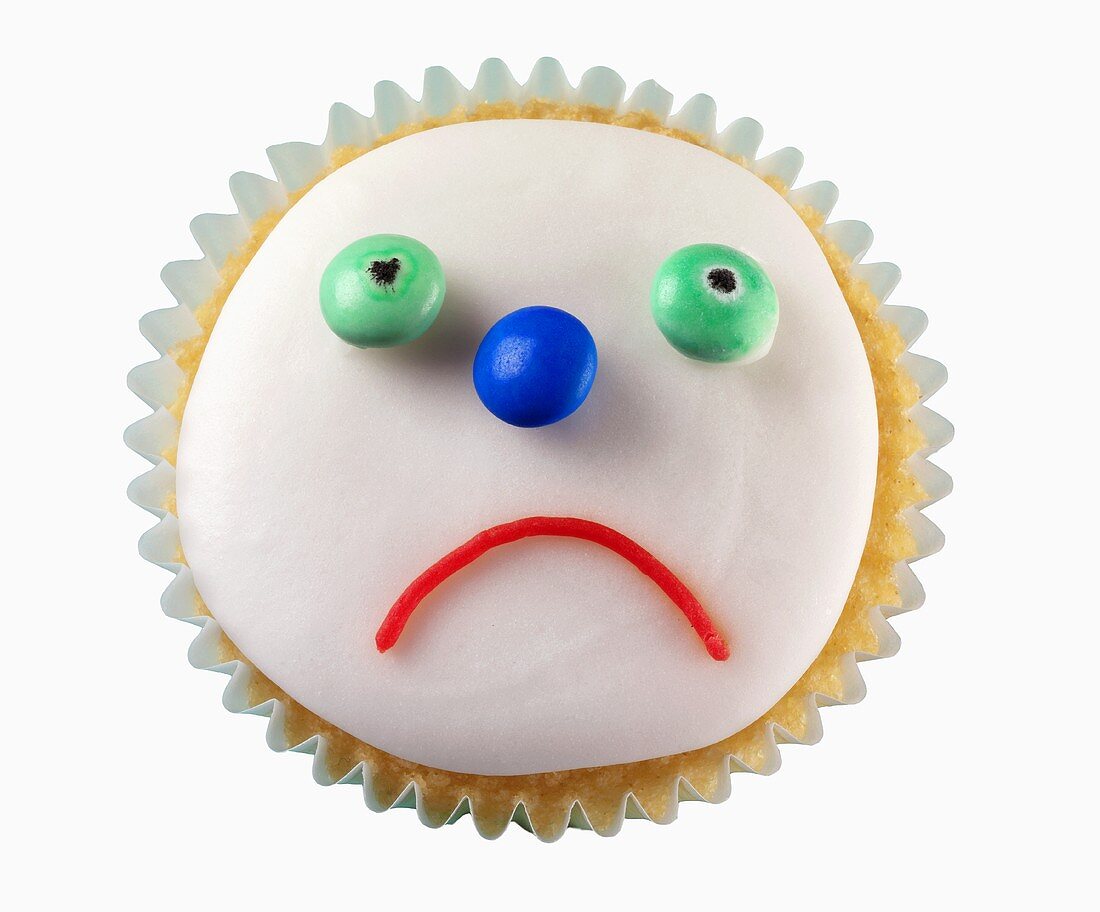 Cupcake mit traurigem Gesicht