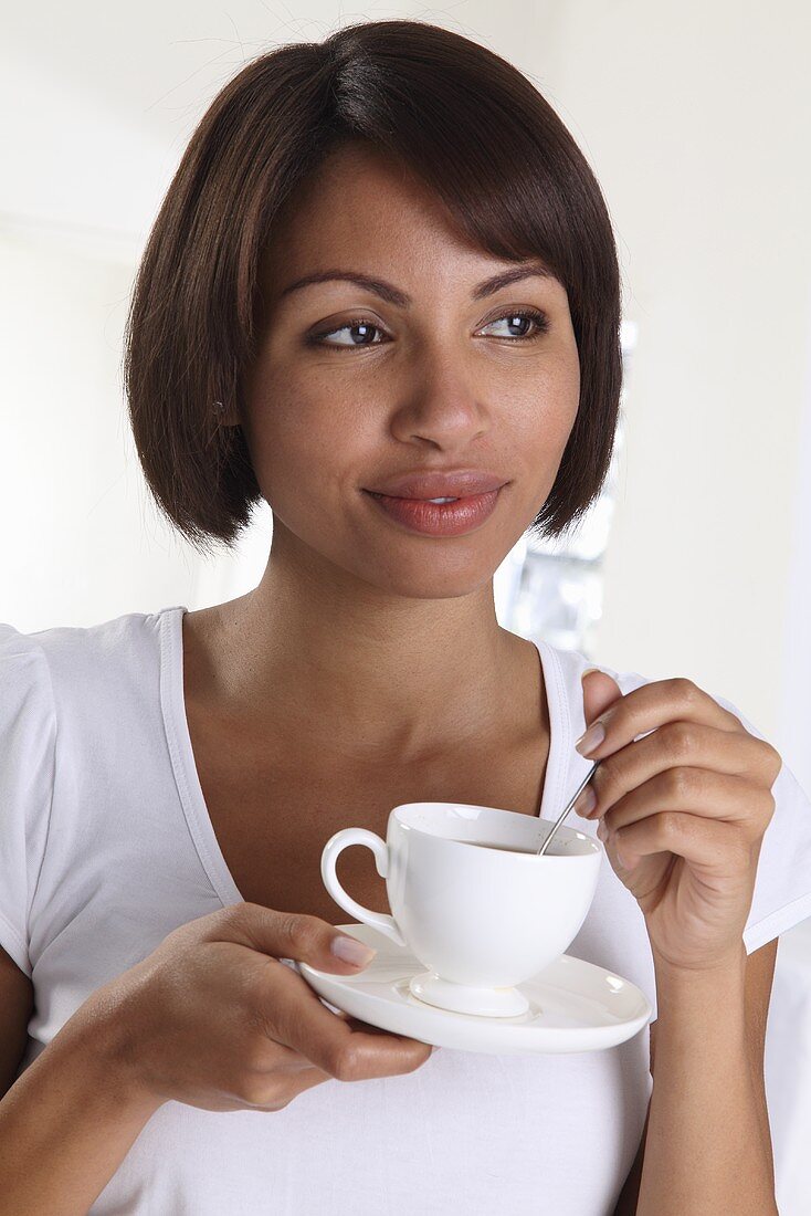 A woman holding a tea cup