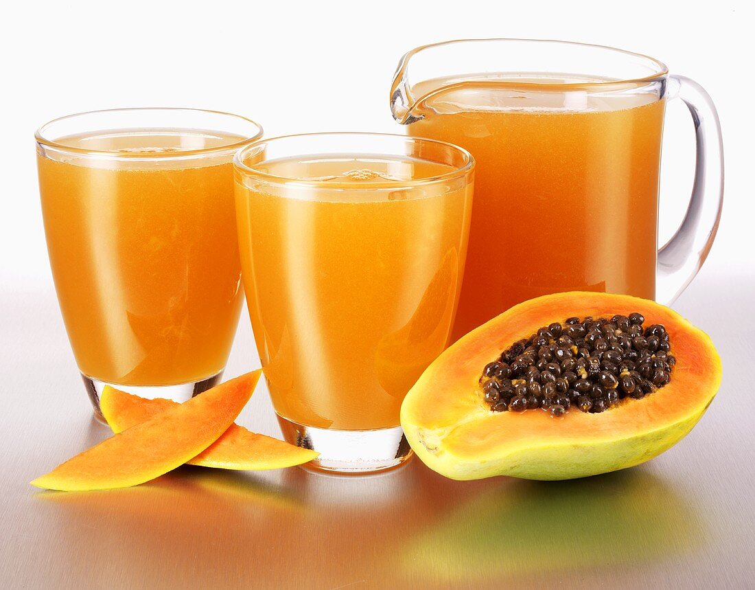 Papaya juice in glasses and a glass jug