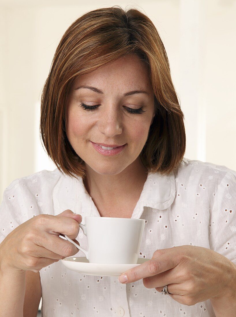 A woman holding a cup of tea