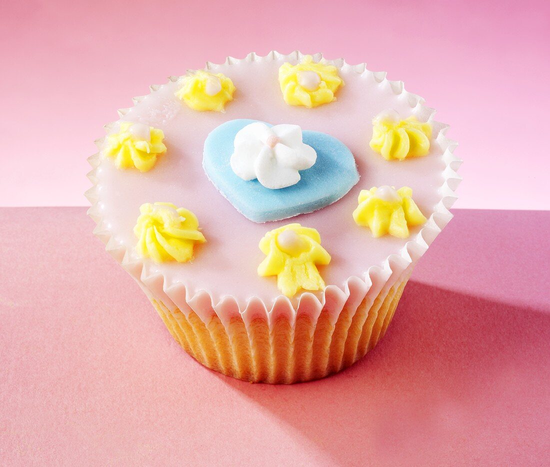 Cupcake with a blue heart and a sugar flower