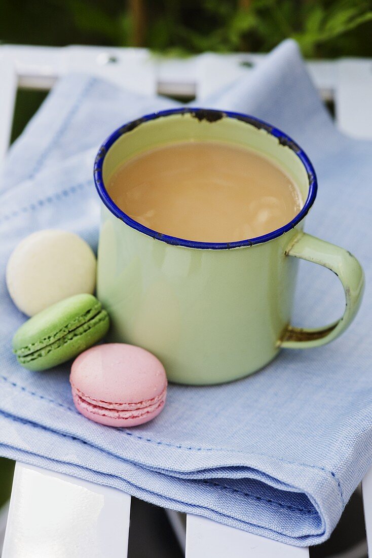 Earl Grey tea in an enamel mug with macaroons