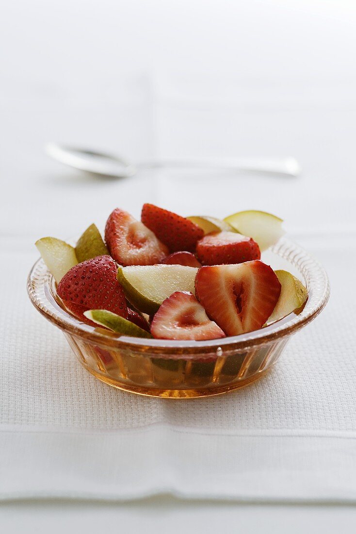 Strawberry and pear salad in a glass bowl