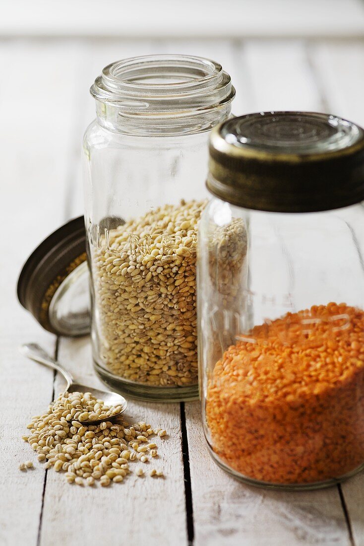 Pearl barley and red lentils in storage jars