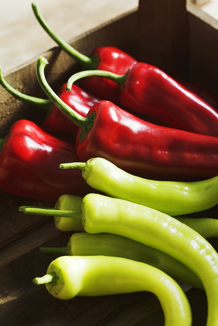 Red and green peppers in a crate