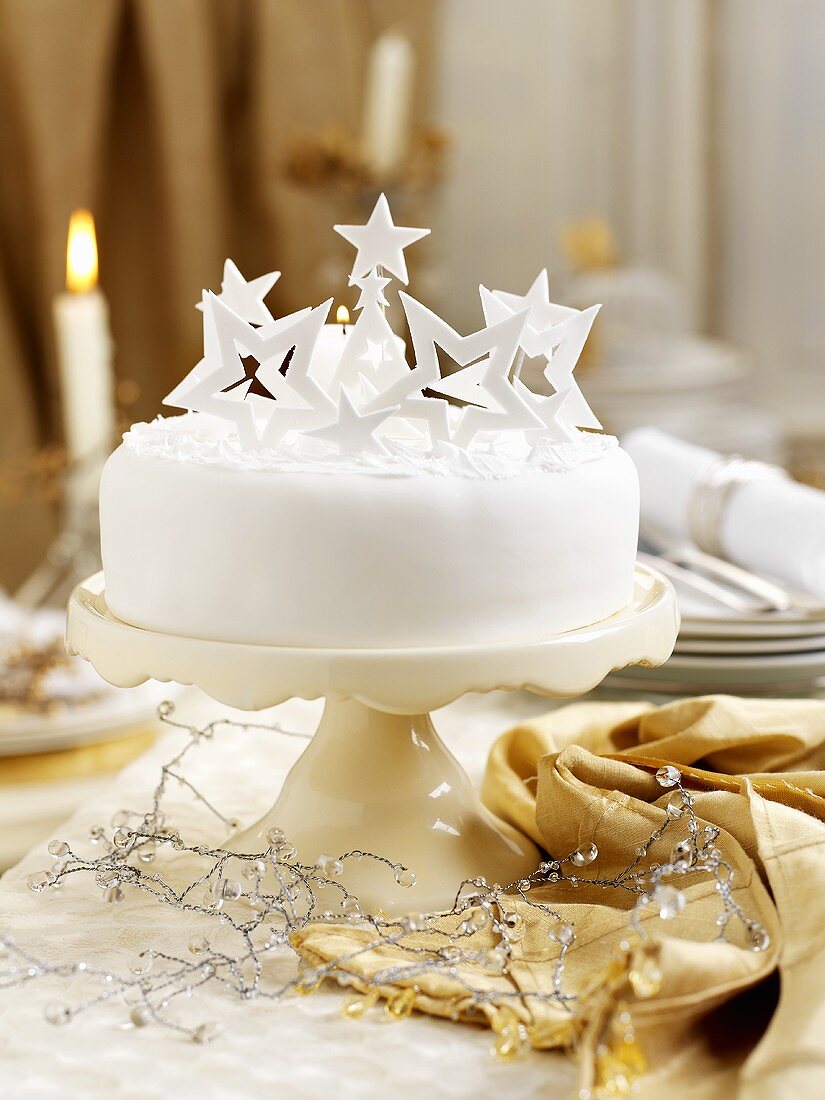 Christmas cake decorated with stars on a cake stand