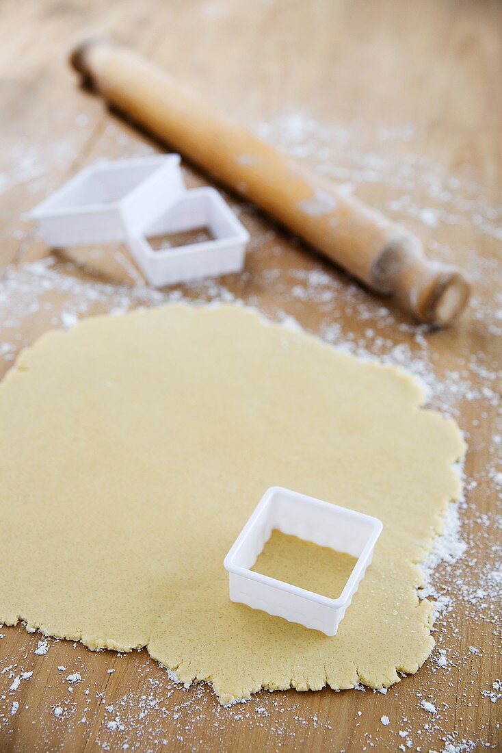 Biscuit dough and a square cutter