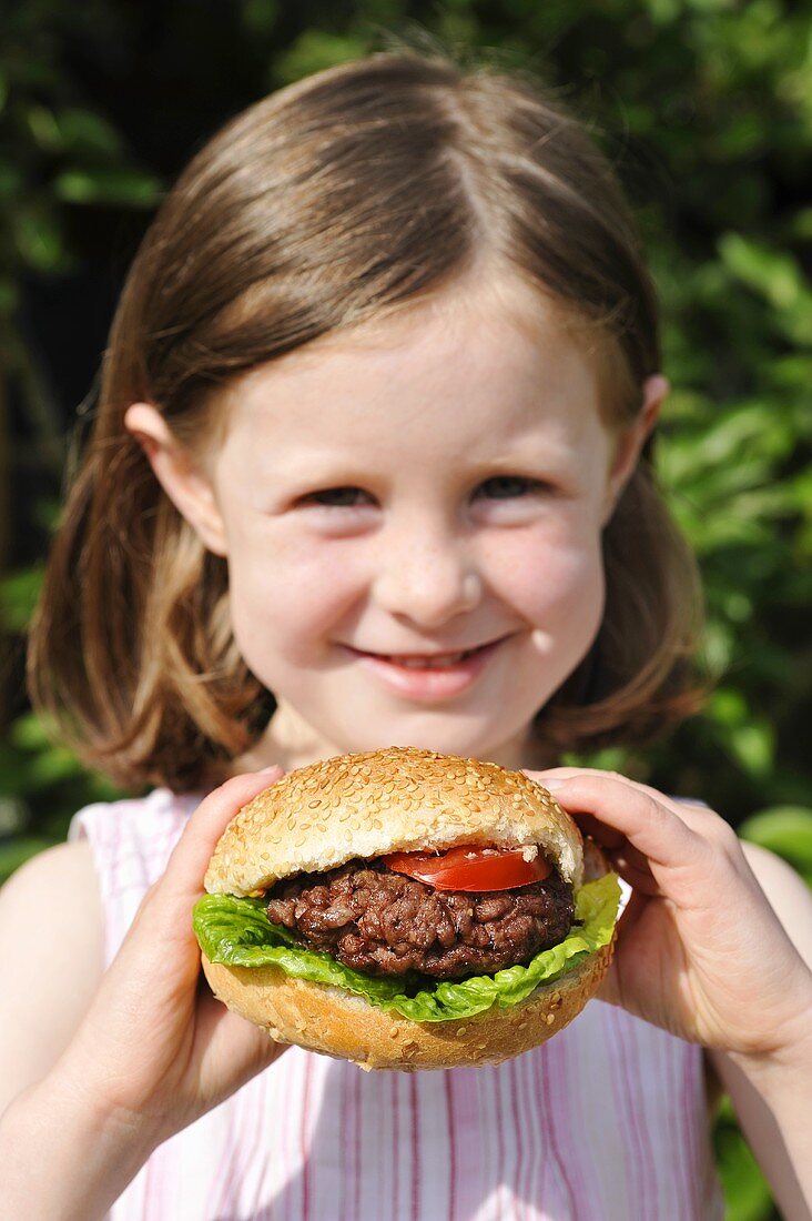 A girl holding a hamburger