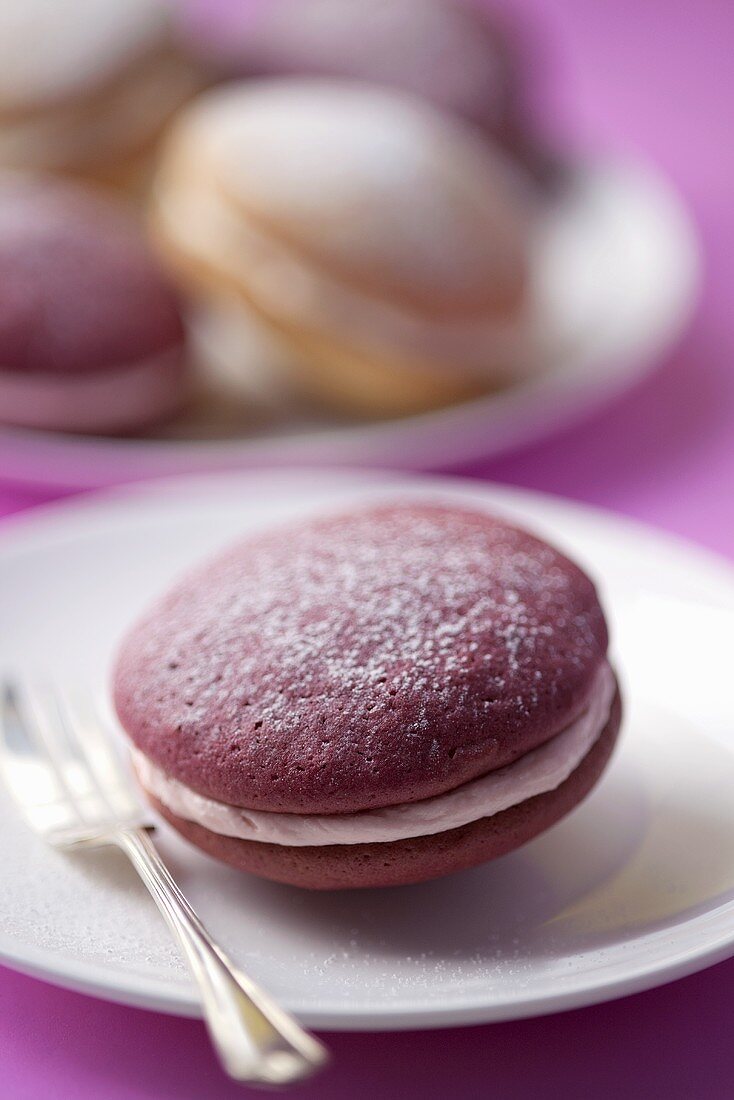 A berry whoopie pie with a dessert fork (close-up)