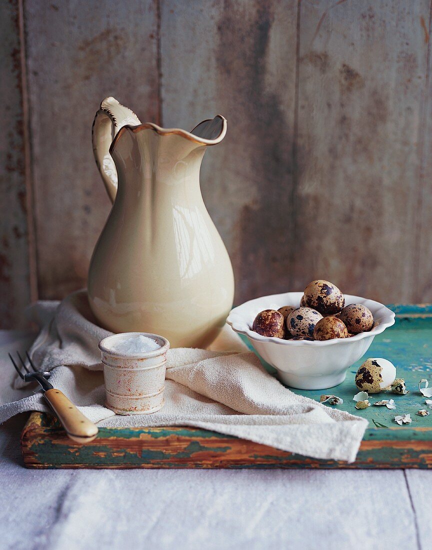 An arrangement of salt, quail's eggs and a ceramic jug