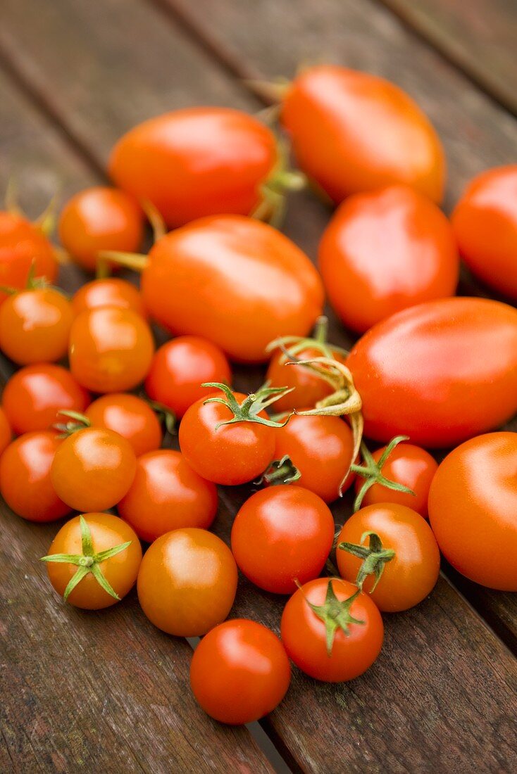 Various tomatoes on a wooden table