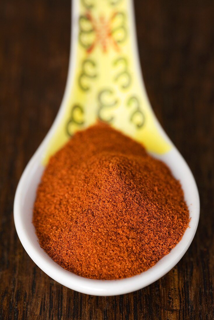 Ground paprika on spoon