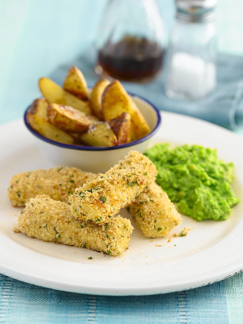 Fish fingers with mushy peas and potatoes wedges