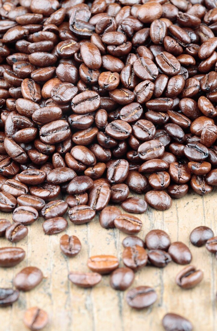 Roasted coffee beans on a wooden surface