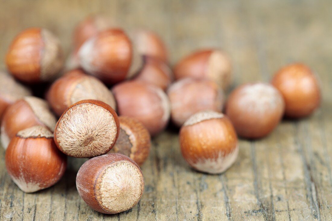 Whole hazelnuts on a wooden surface