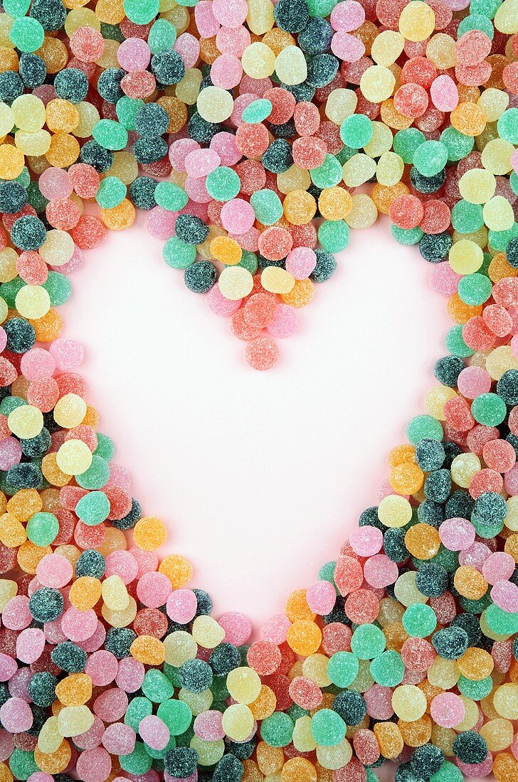 Bonbons creating a heart in the negative space