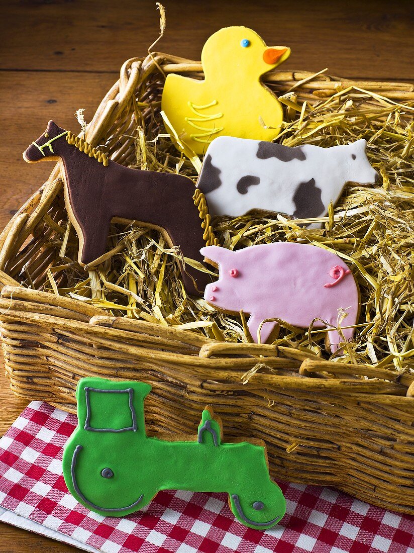 Humorous cookies (animal shapes, tractor) in a wicker basket