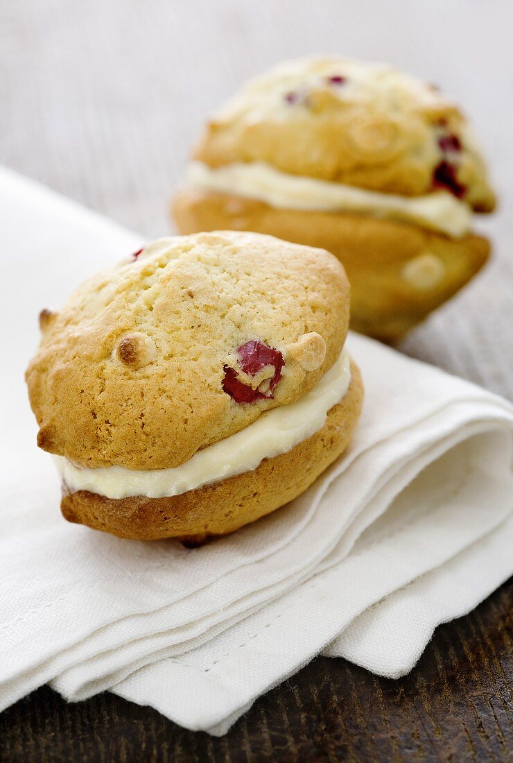 Cranberry whoopie pies, filled with white chocolate cream on a napkin