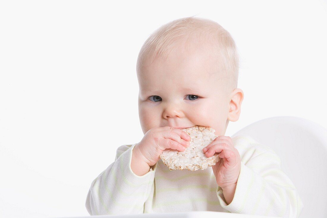 Baby eating a rice cracker