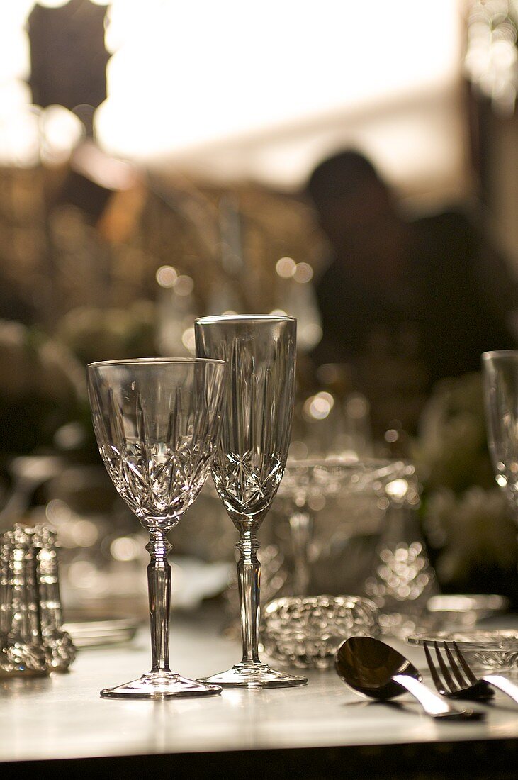 Crystal glasses, bowls and cutlery on a table