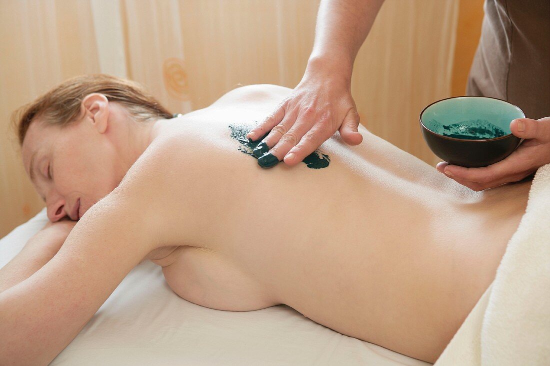 Green clay body skin theraphy massage, woman