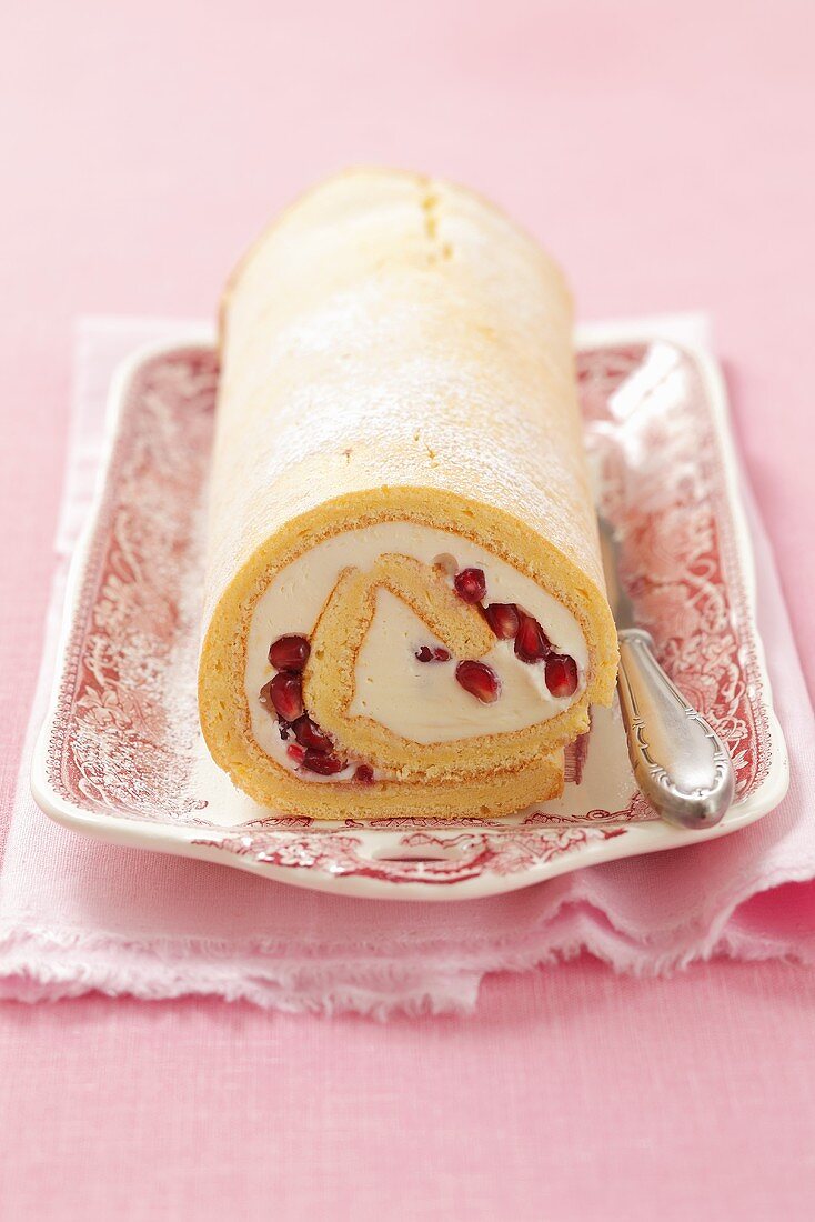 Sponge roll with mascarpone and pomegranate seeds