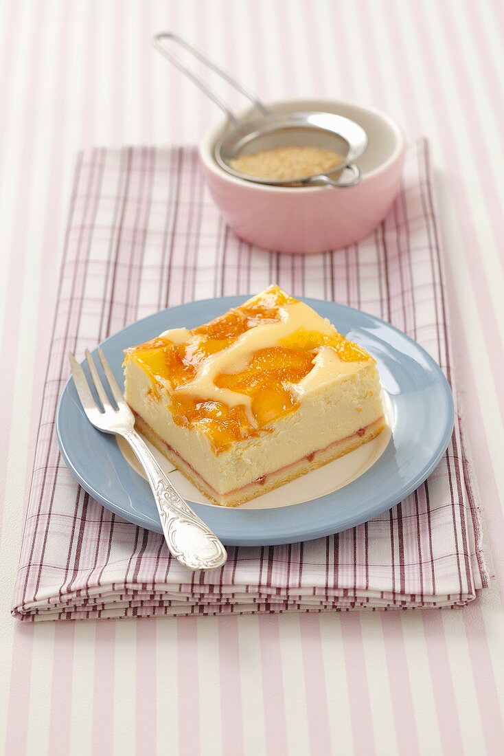 A slice of peach cheesecake