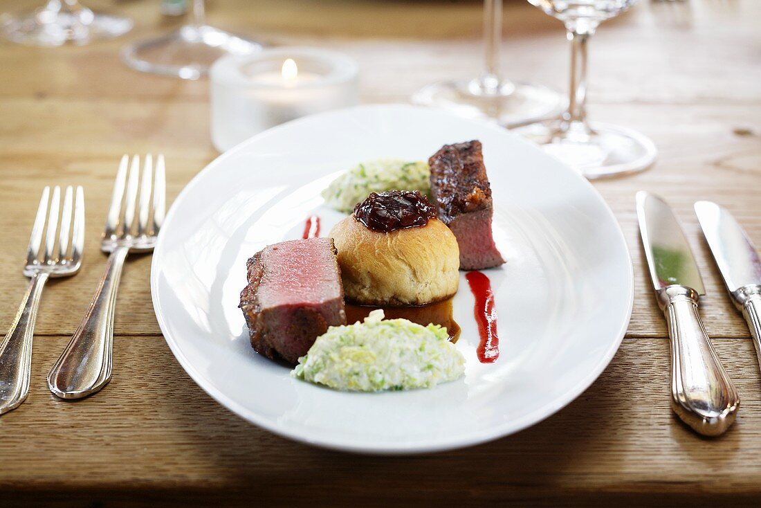 Saddle of venison with a dried fruit and nut crust and fig buchteln (baked, sweet yeast dumpling)