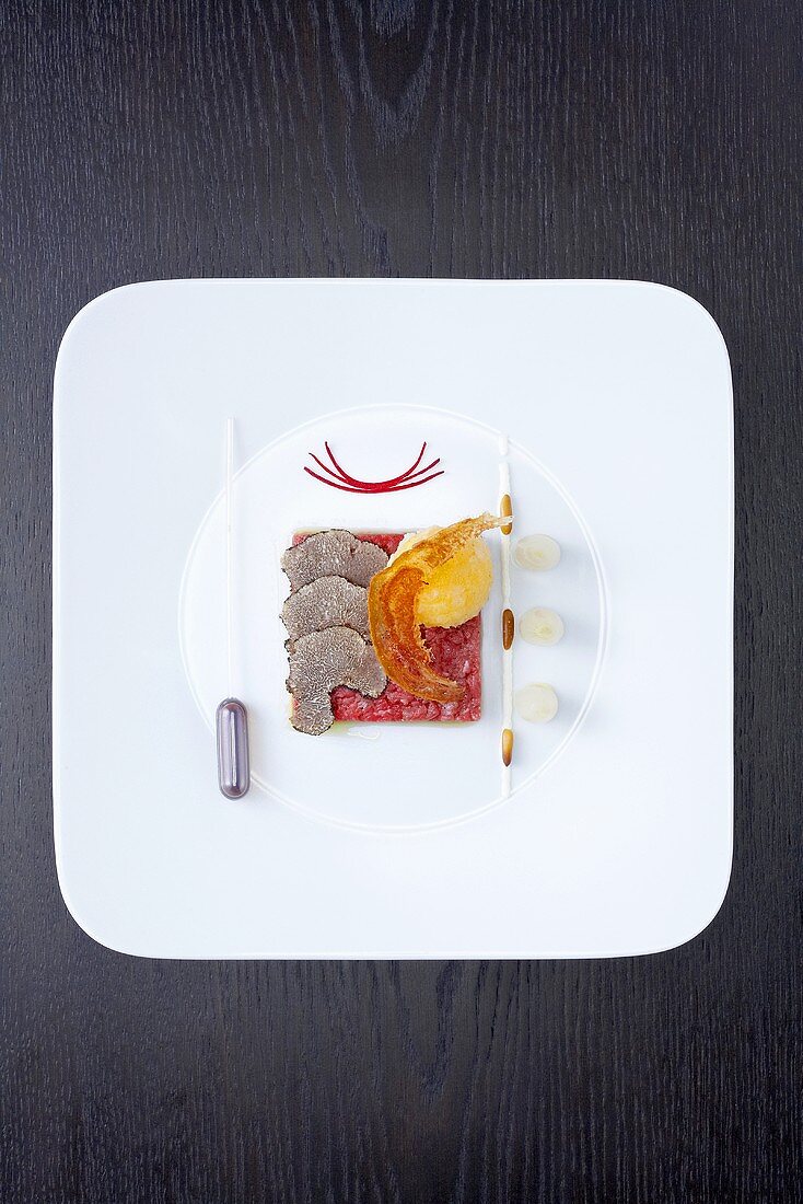 Marinated veal fillet with baked egg yolk and truffles