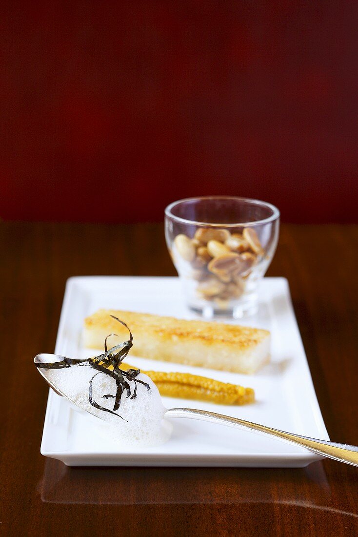 Fried sticky rice slices with peanut milk, nori and pumpkin compote