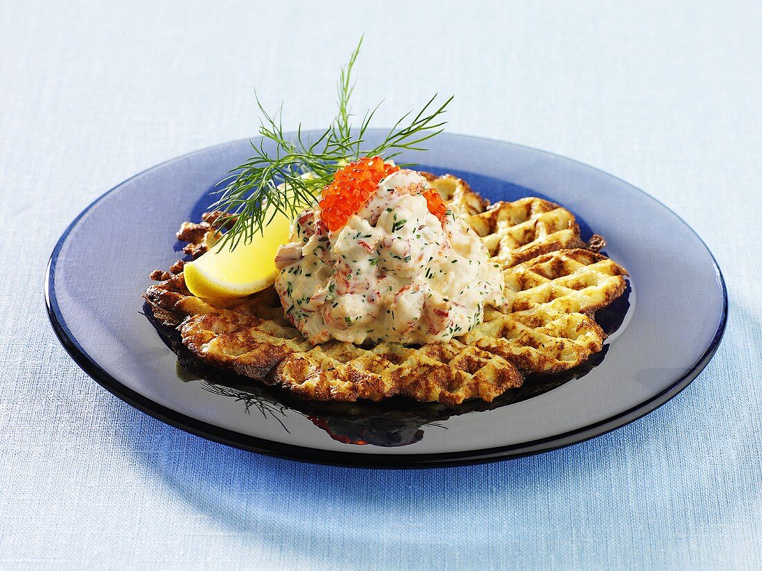 Waffles with crayfish salad and caviar