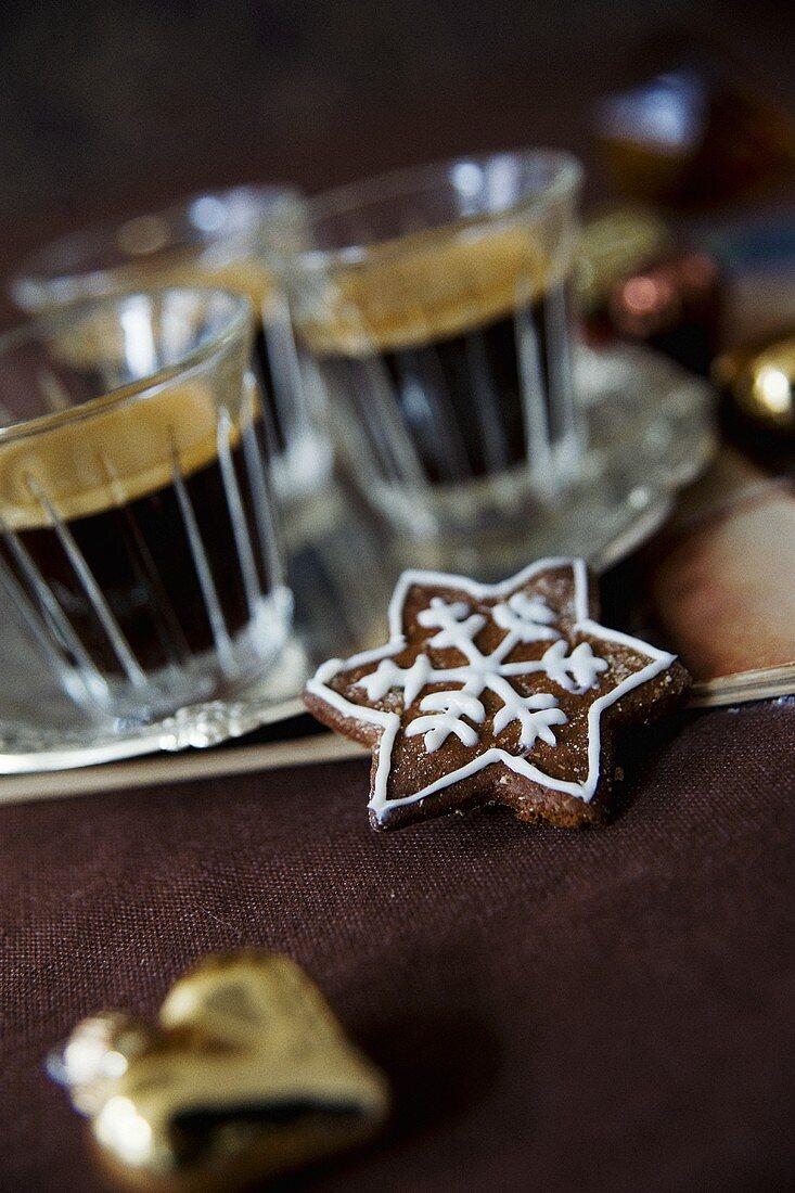Star-shaped Spekulatius (German Christmas biscuits) and glasses of espresso
