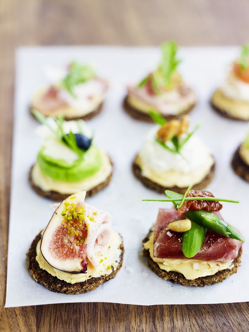 Canapes with mustard butter and various toppings