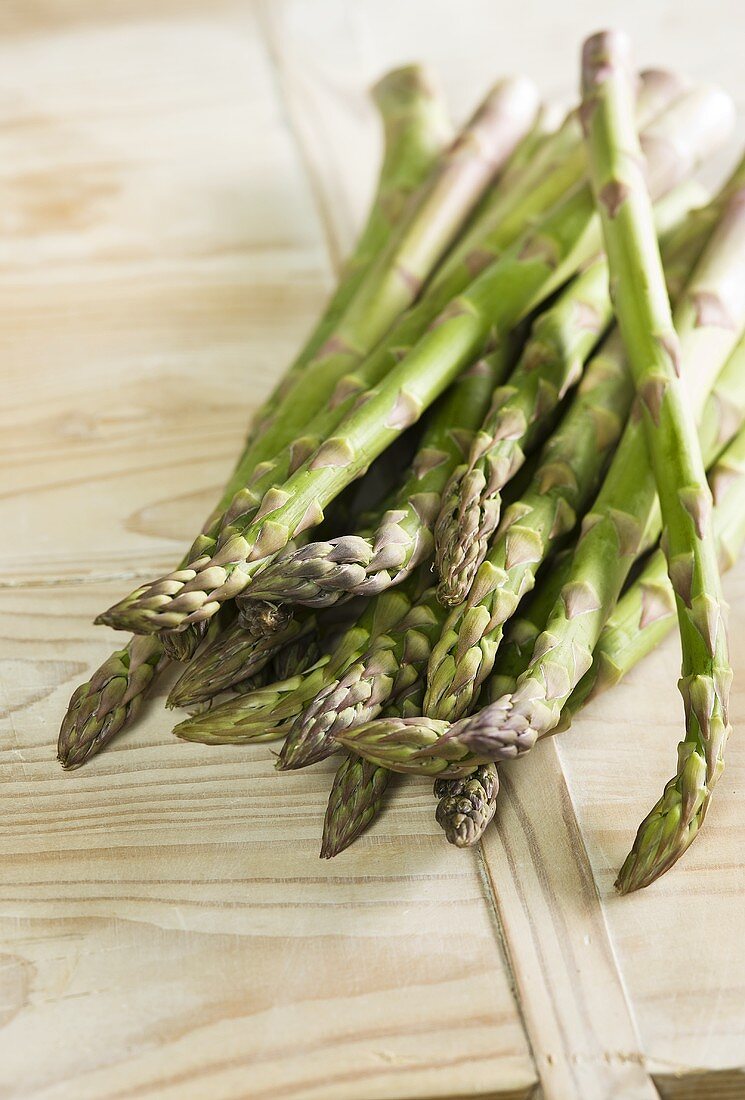 Green asparagus on wooden background