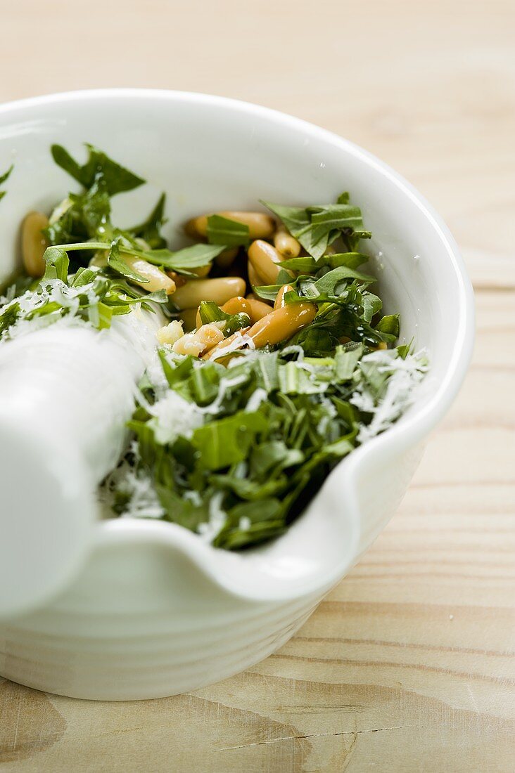 Rocket pesto being prepared in a mortar