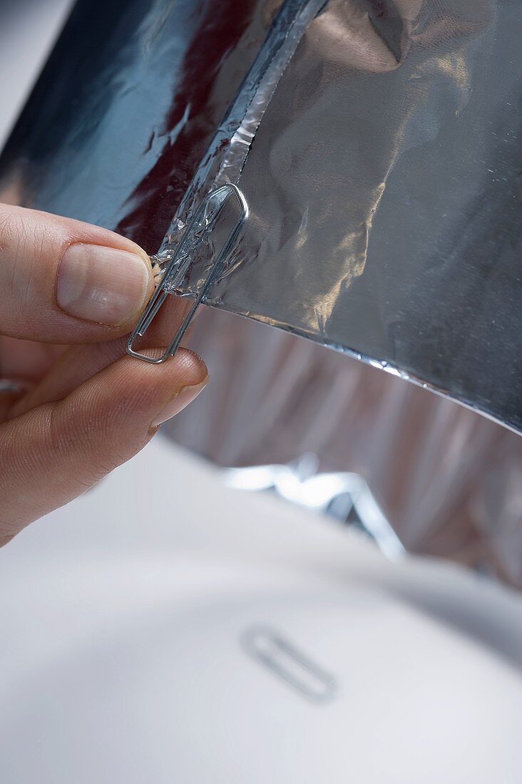 Aluminium foil being fastened