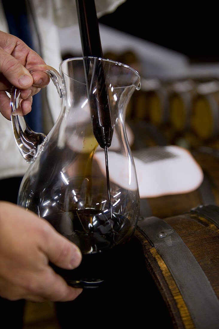 Balsamic vinegar being poured into a glass jug