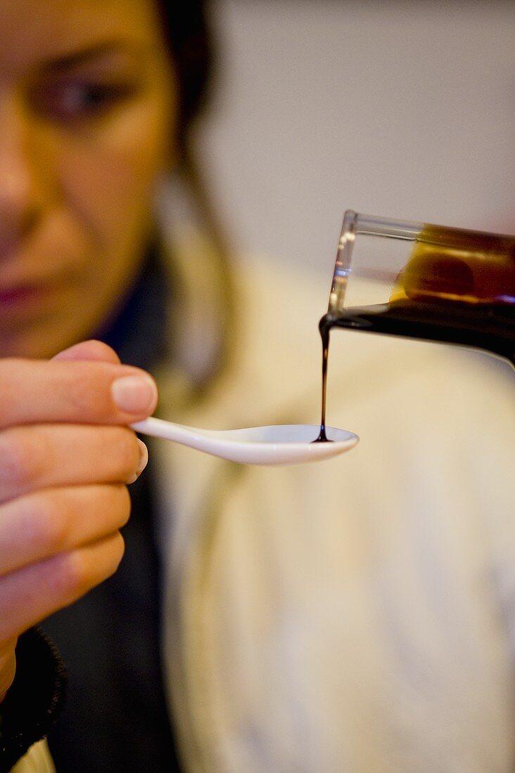 Balsamic vinegar being drizzled onto a spoon