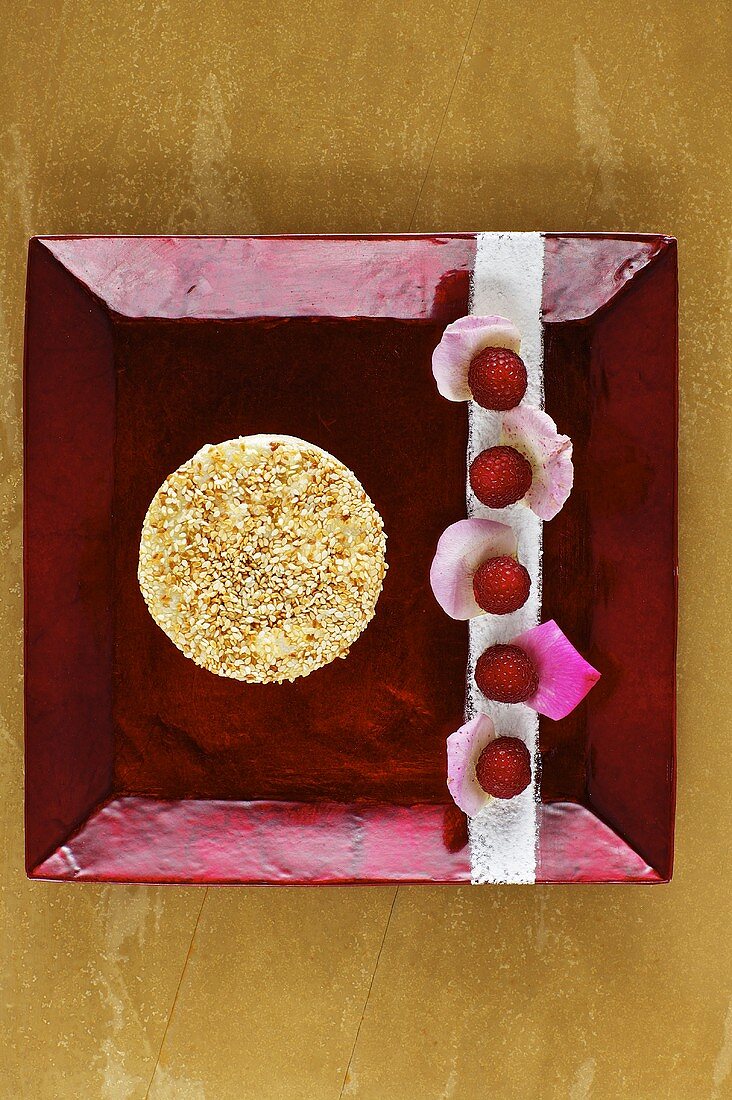 Sesame mousse with rose petals and raspberries