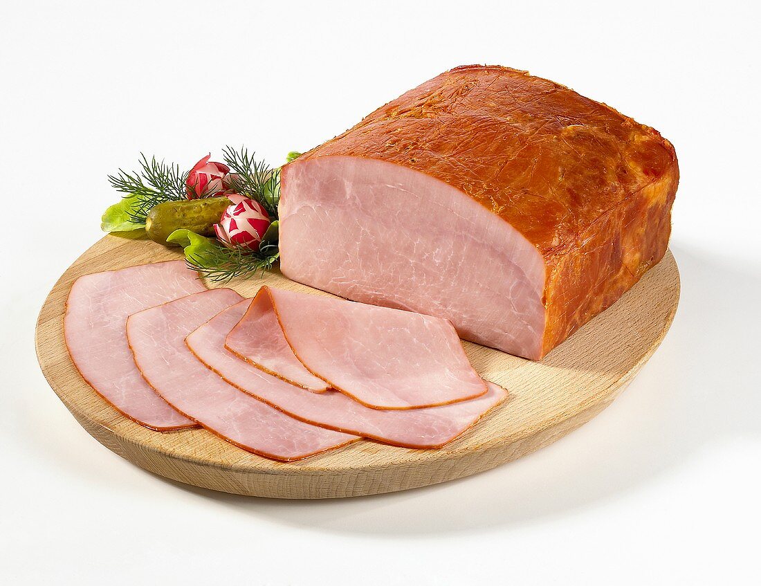 Sliced country ham on a wooden plate