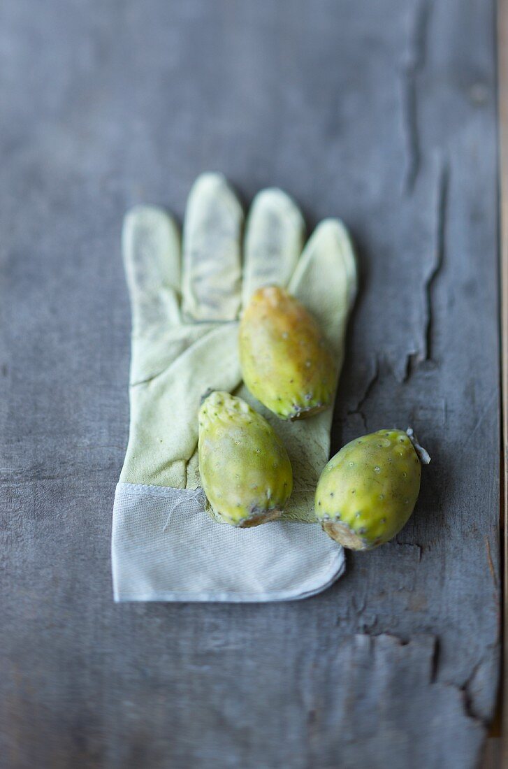 Three prickly pears on a glove