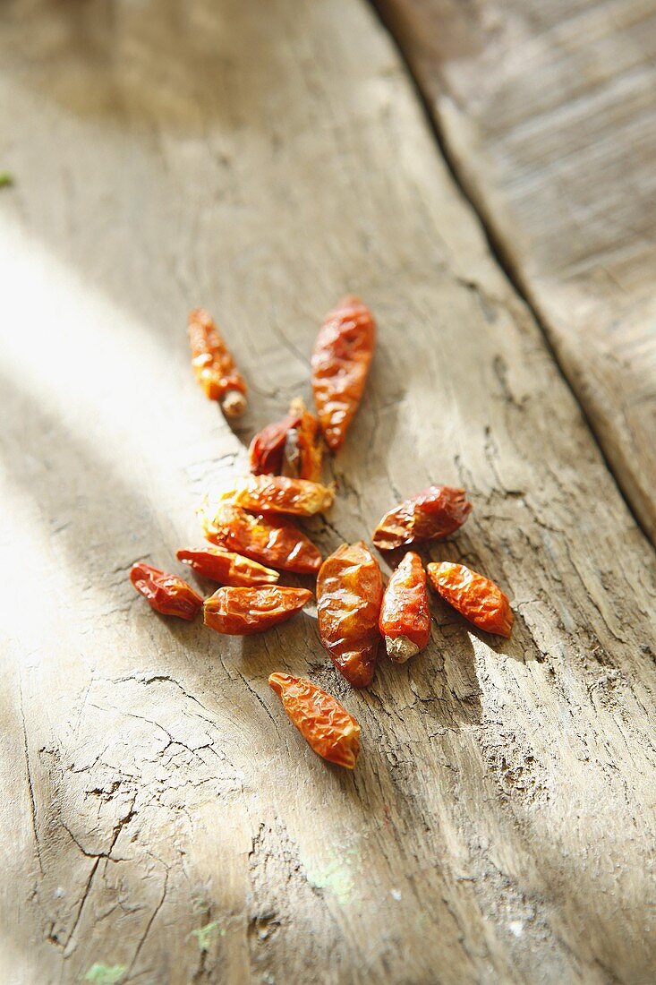 Dried chillis on a wooden surface